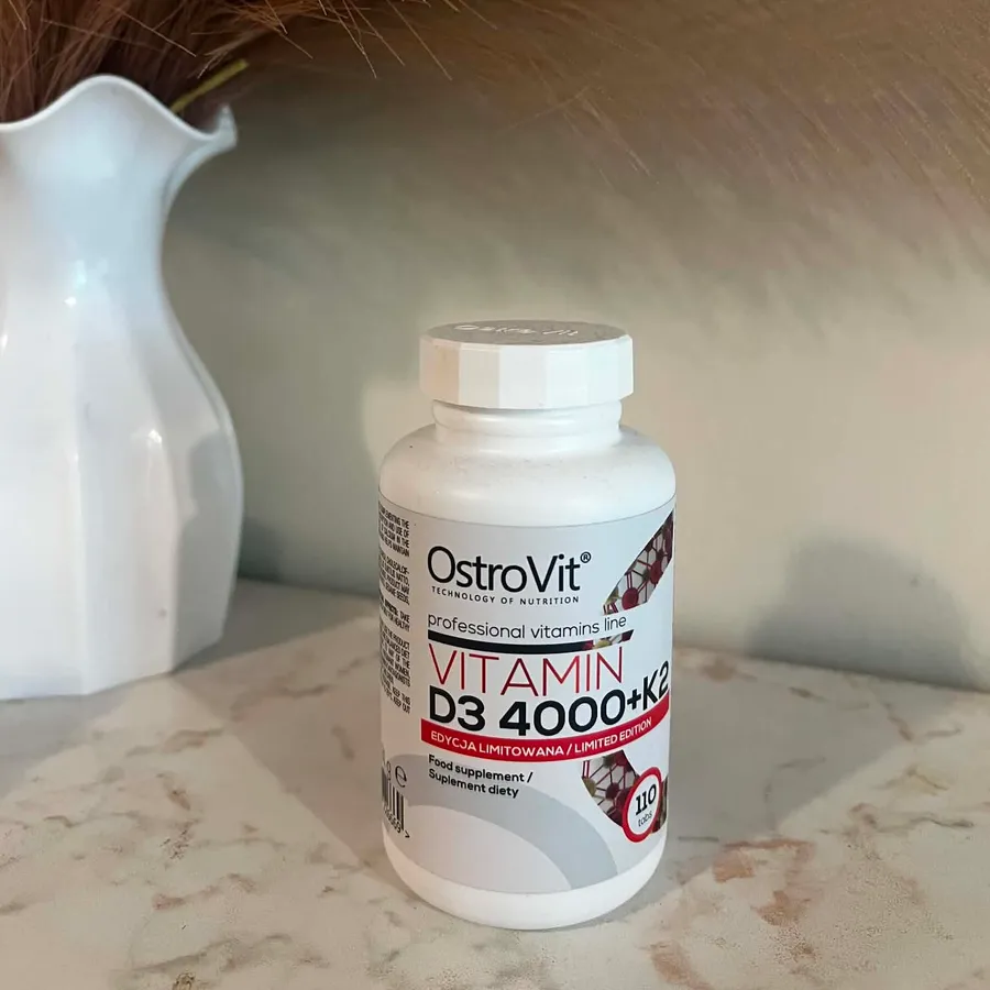 A raw phone photo of a supplement bottle on a kitchen counter